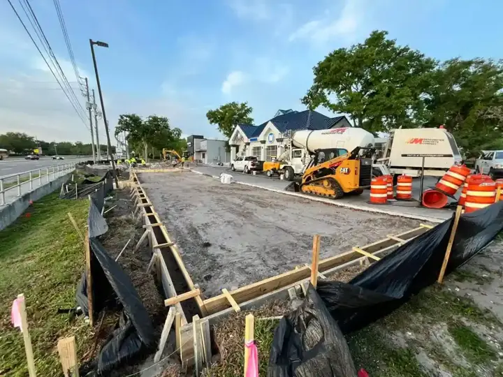 Formed commercial concrete pad along a road with equipment on site in Little Elm, TX
