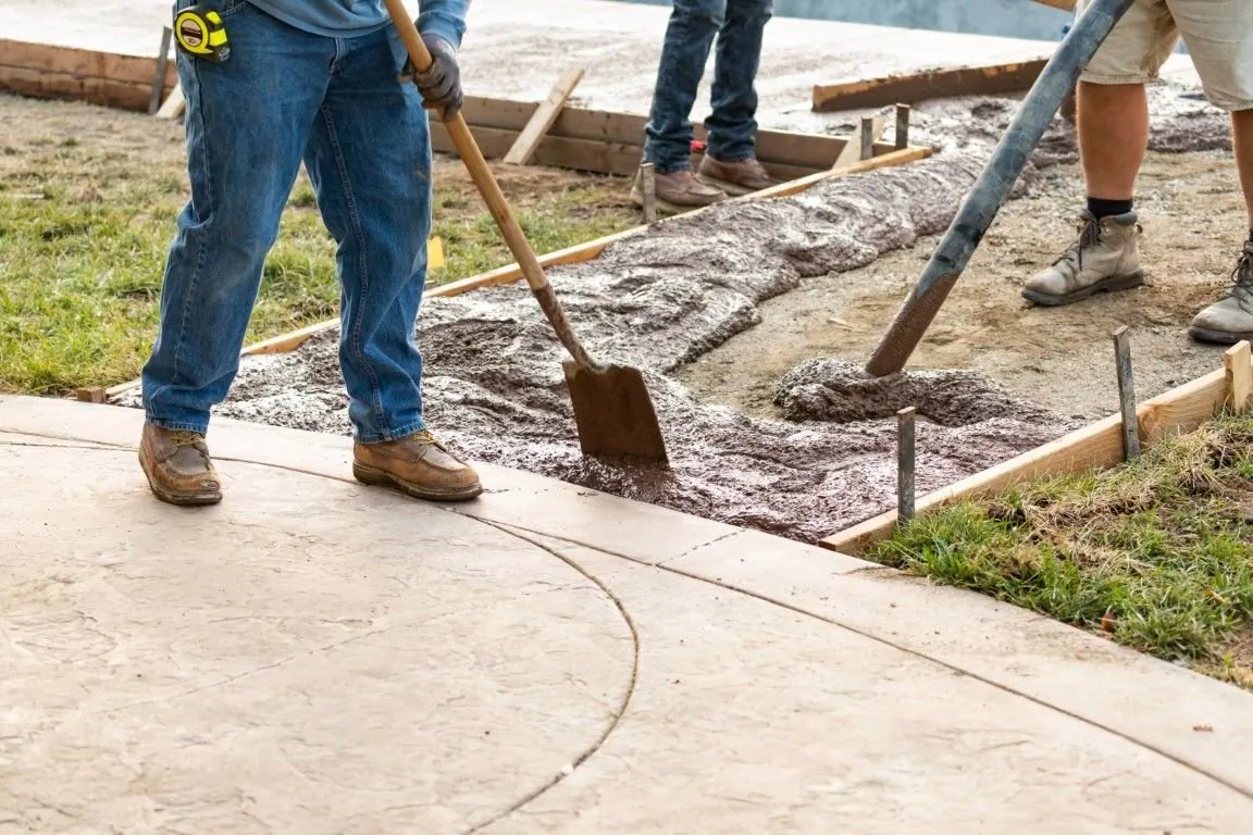 Our crew spreading fresh concrete for a curved walkway at a home near Little Elm, TX