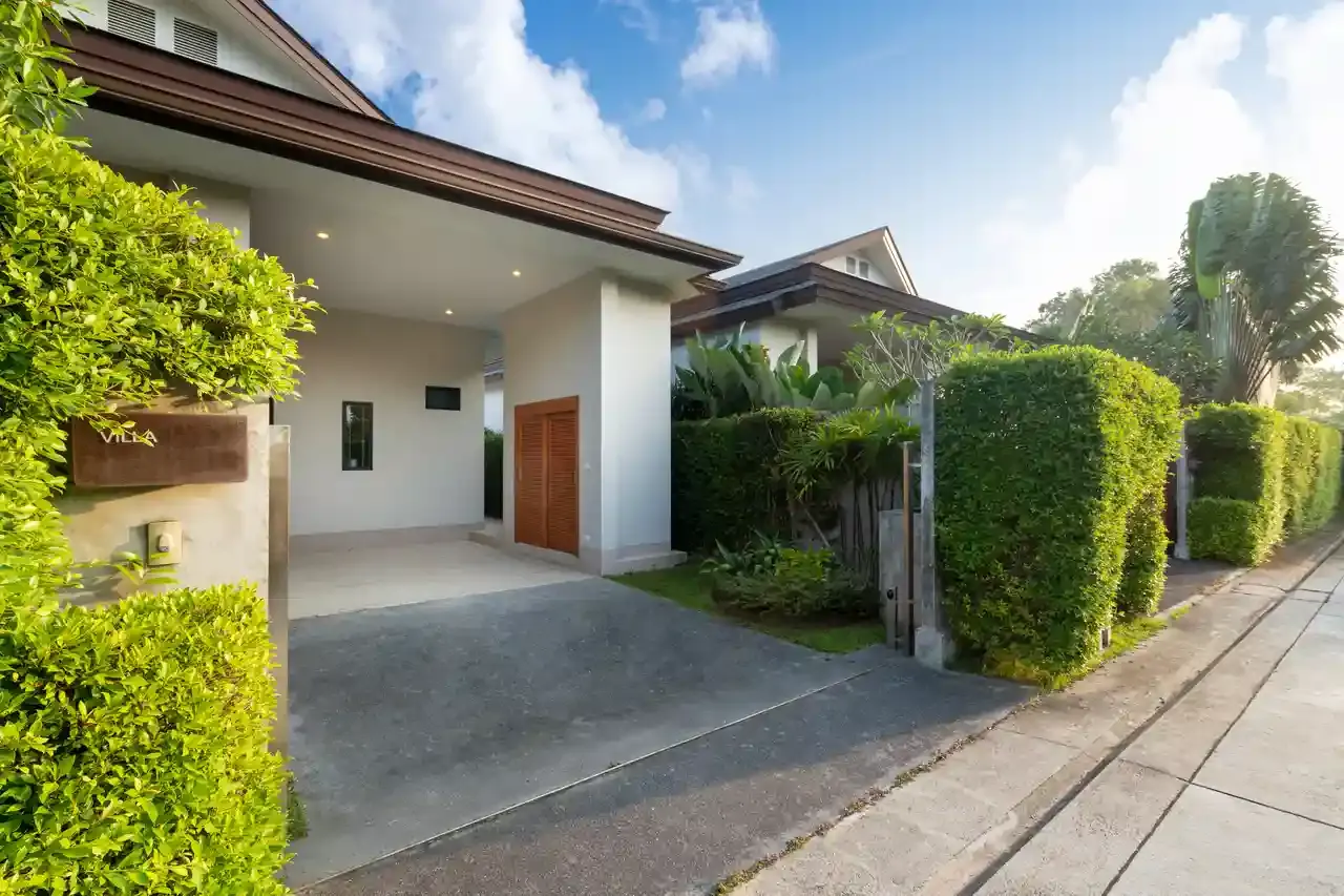 Concrete driveway leading to a garage and carport at a Little Elm, TX home