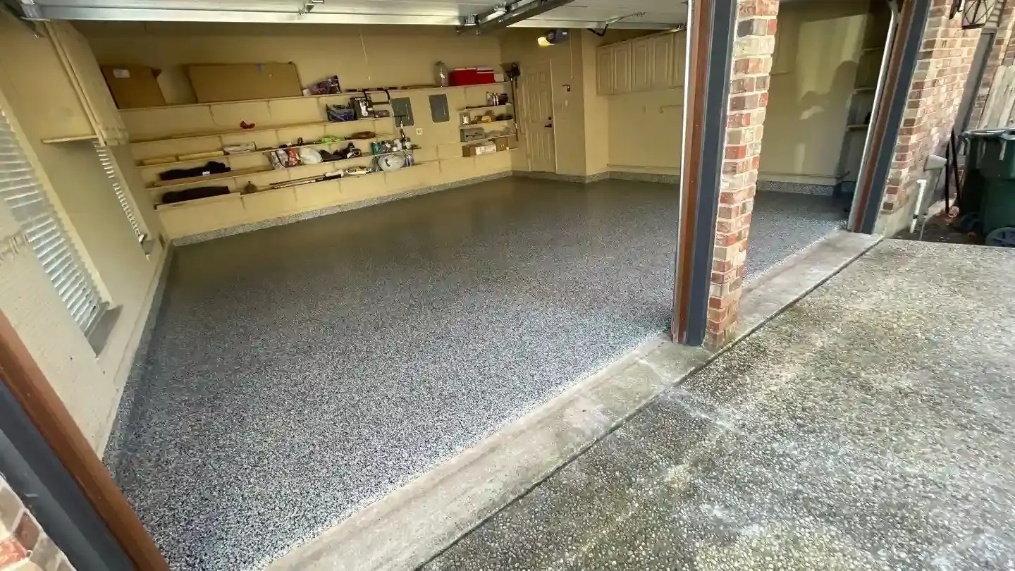 Flake-coated garage floor with a clean, sealed finish in a Little Elm, TX home