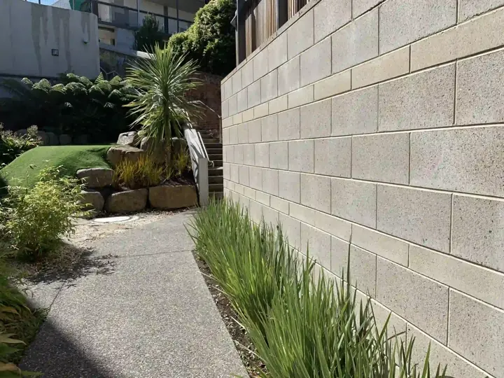 Tall block retaining wall with a planting bed above it at a home in Little Elm, TX